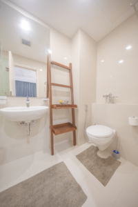 Relax and unwind in the modern ensuite bathroom of the master bedroom at Aganthuka Villas, complete with a spacious glass-walled shower and ample storage space.