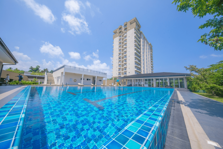 Galle Luxury Apartment Accommodations Outdoor full-size swimming pool with lounge chairs, showers, and changing room at Aganthuka Villas